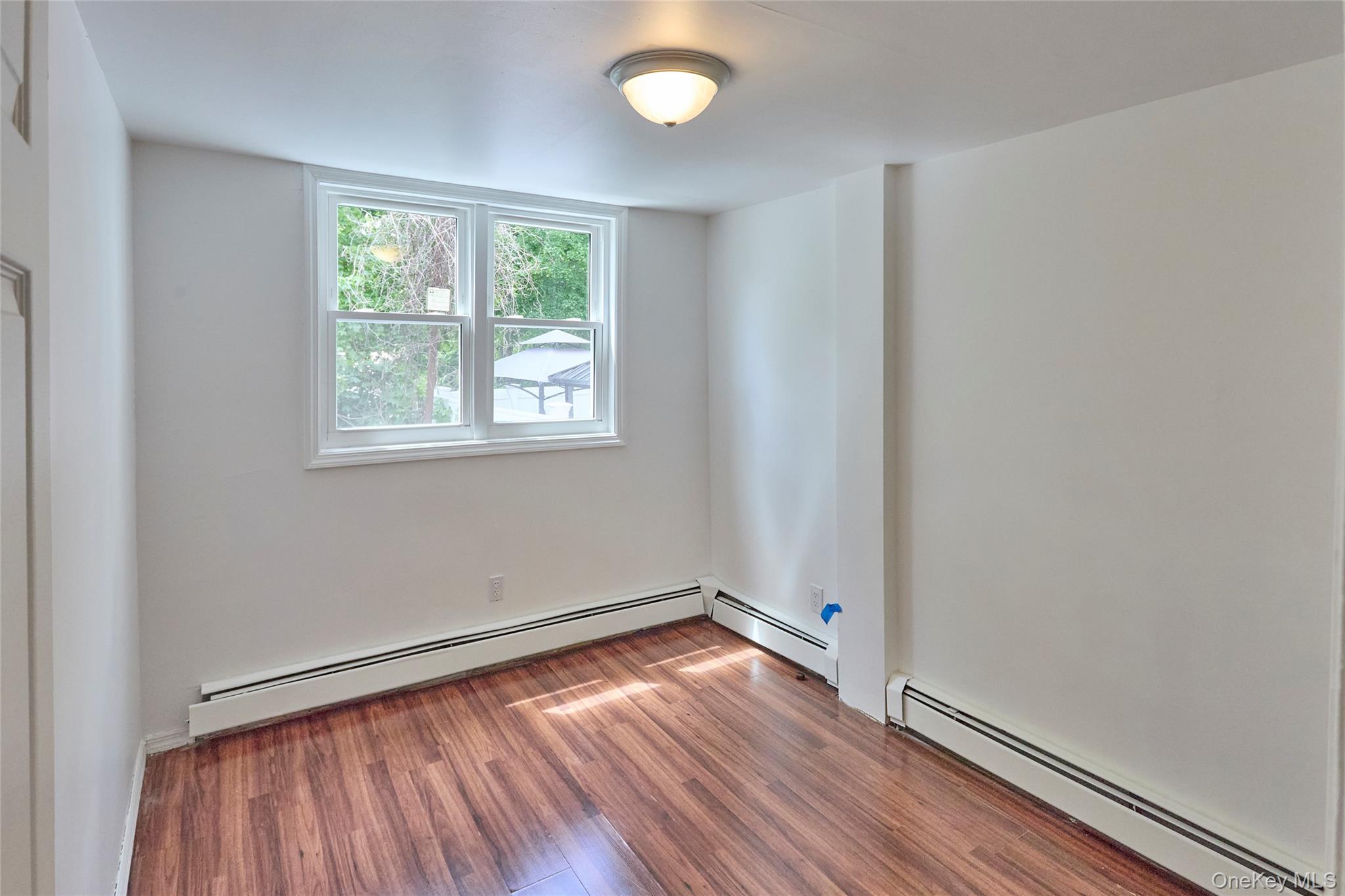 208 North James Street Peekskill, NY 10566 - Photo 5 of 13 Bedroom with laminate wood floor (Unit 1)