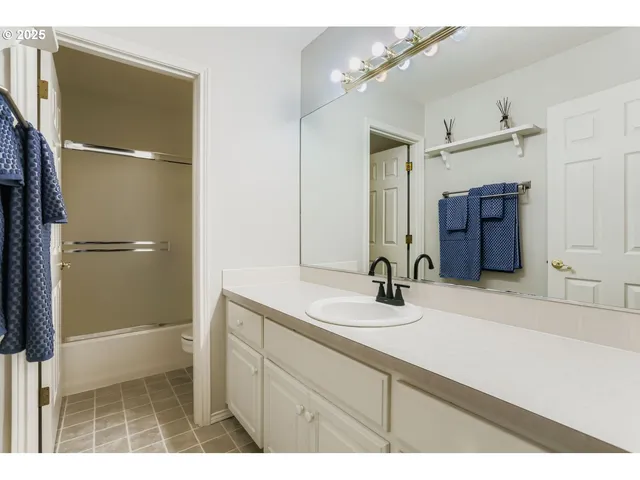 a bathroom with a sink a mirror and a shower
