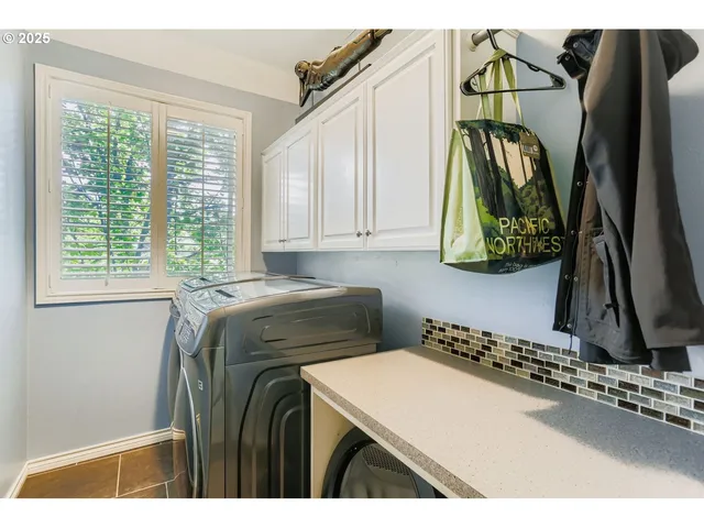 a utility room with a window and a rug