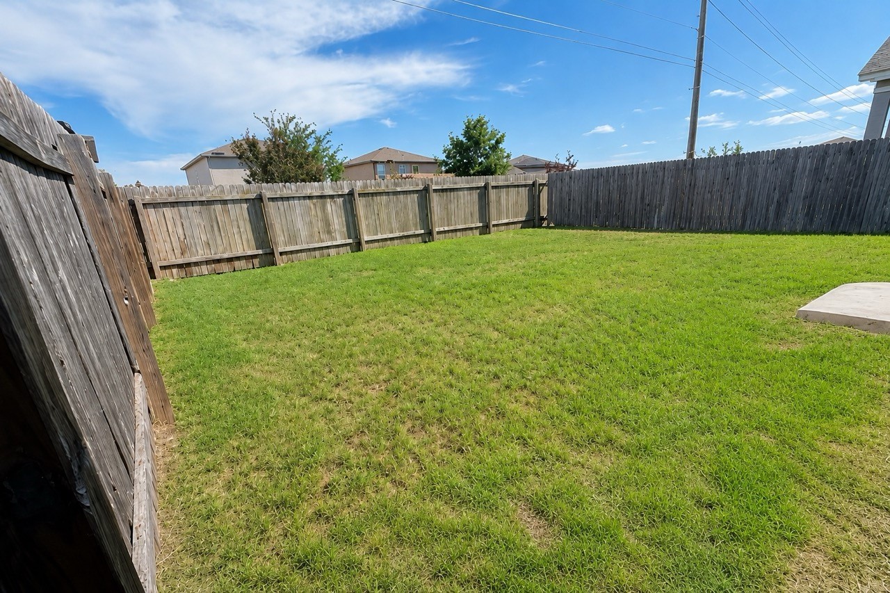 253 Wonderful Life Way Jarrell, TX 76537 - Photo 3 of 3 a view of a backyard with a garden