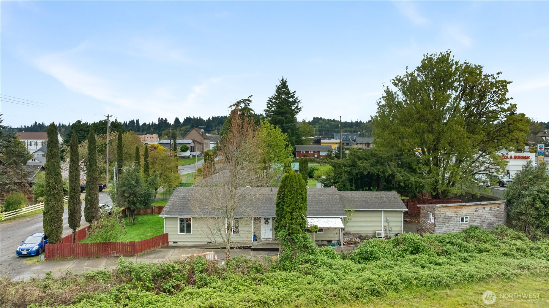 an aerial view of a house with garden space and trees