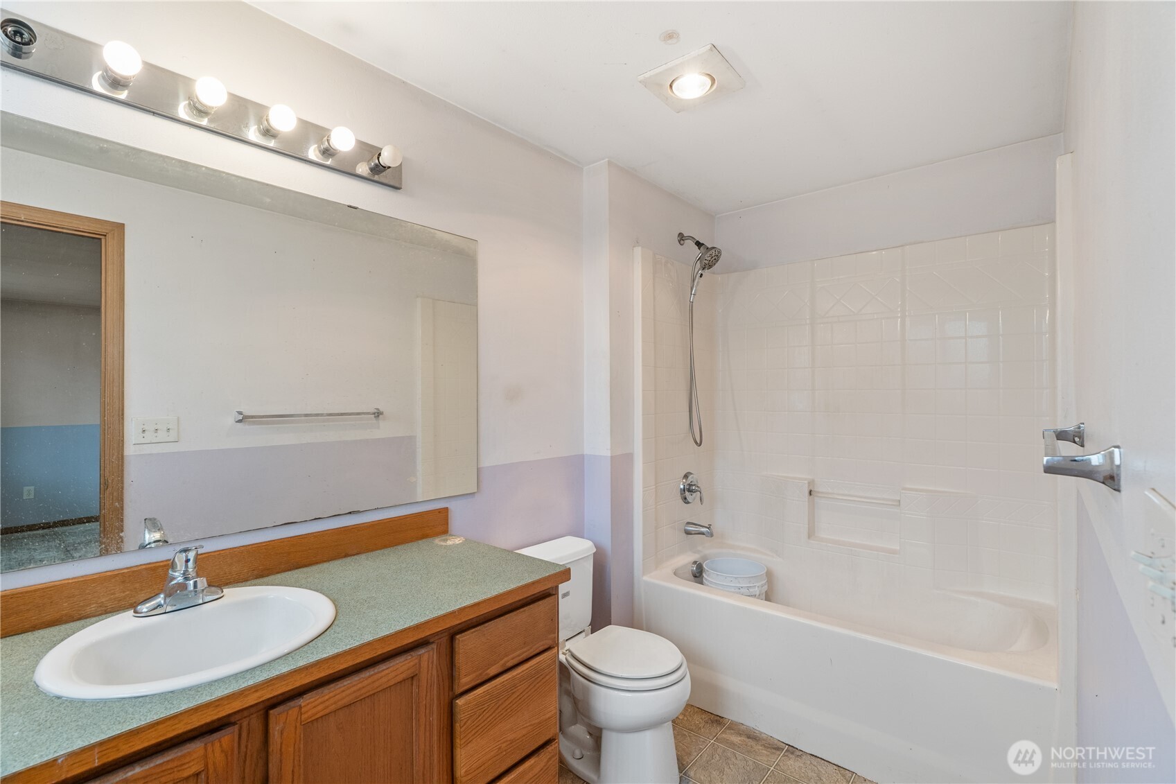 320 South 4th Street Elma, WA 98541 - Photo 19 of 35 a bathroom with a granite countertop sink a toilet a mirror a bathtub and shower