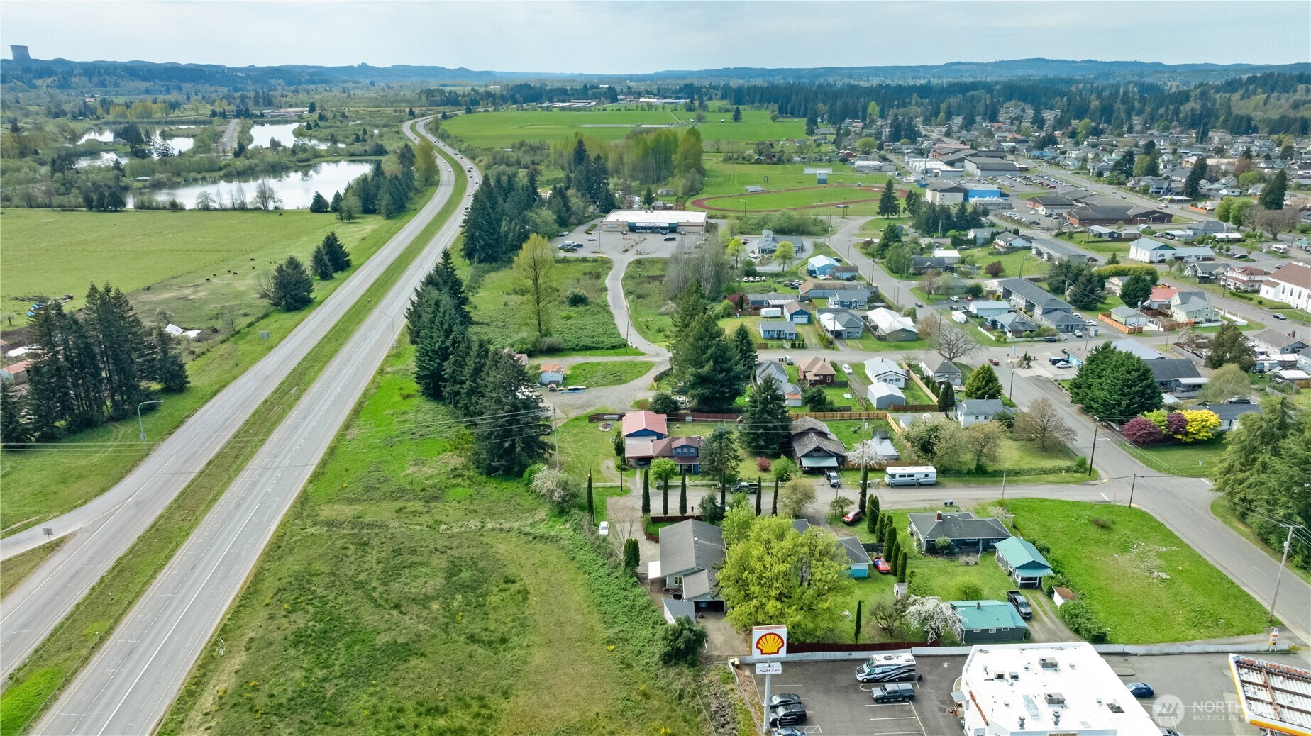 320 South 4th Street Elma, WA 98541 - Photo 34 of 35 an aerial view of a house with a yard and lake view