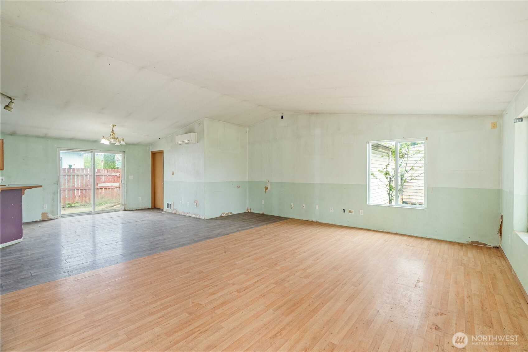 320 South 4th Street Elma, WA 98541 - Photo 4 of 35 an empty room with wooden floor and windows