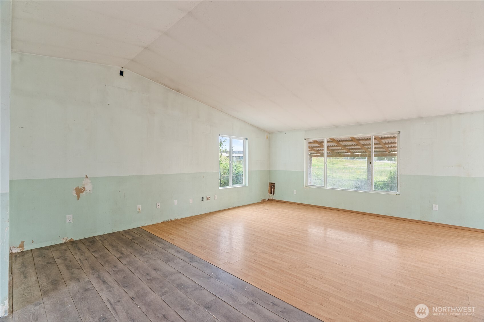 320 South 4th Street Elma, WA 98541 - Photo 5 of 35 an empty room with wooden floor and windows