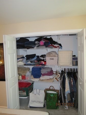 312 America Street Fall River, MA 02721 - Photo 15 of 26 a view of walk in closet with clothes and shoes