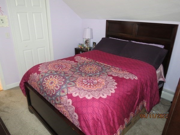 312 America Street Fall River, MA 02721 - Photo 16 of 26 a bed sitting in a bedroom next to a window