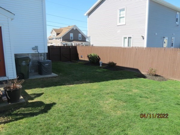 312 America Street Fall River, MA 02721 - Photo 24 of 26 a backyard of a house with lots of green space
