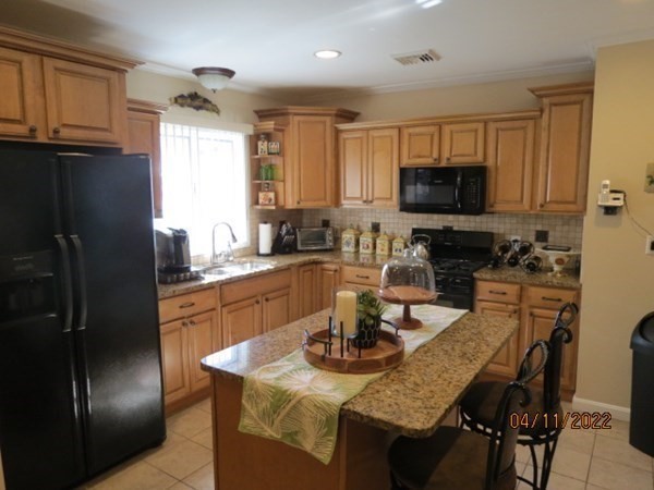 312 America Street Fall River, MA 02721 - Photo 5 of 26 a kitchen with a refrigerator and a stove top oven