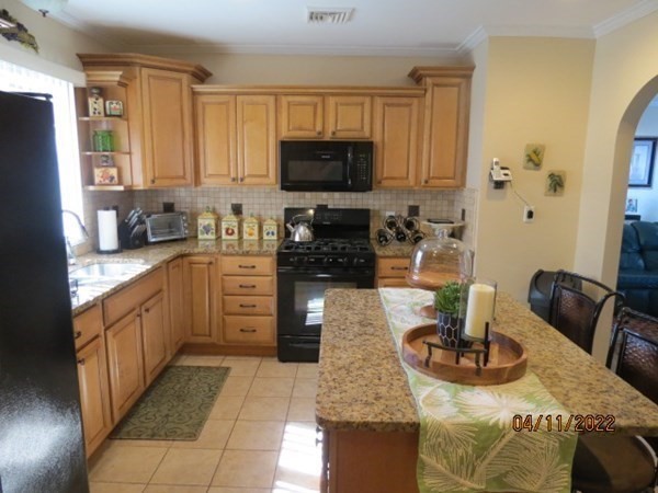 312 America Street Fall River, MA 02721 - Photo 7 of 26 a kitchen with stainless steel appliances granite countertop a sink dishwasher stove refrigerator and cabinets