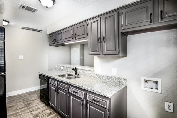 a kitchen with stainless steel appliances granite countertop a sink and cabinets