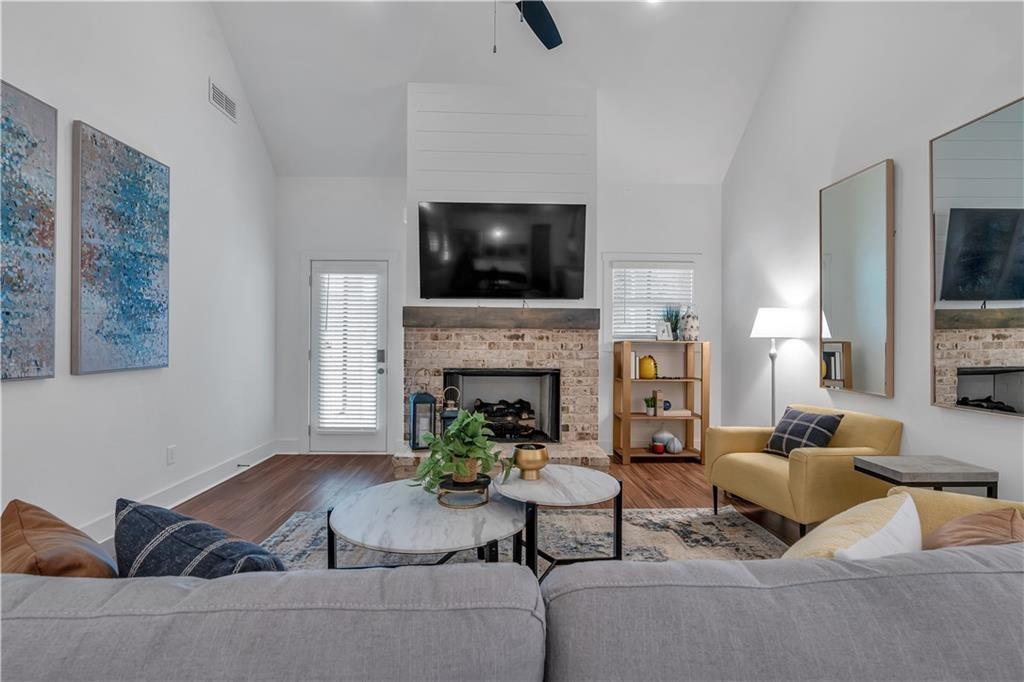 50 Puckett Road Emerson, GA 30137 - Photo 17 of 26 a living room with furniture a flat screen tv and a fireplace