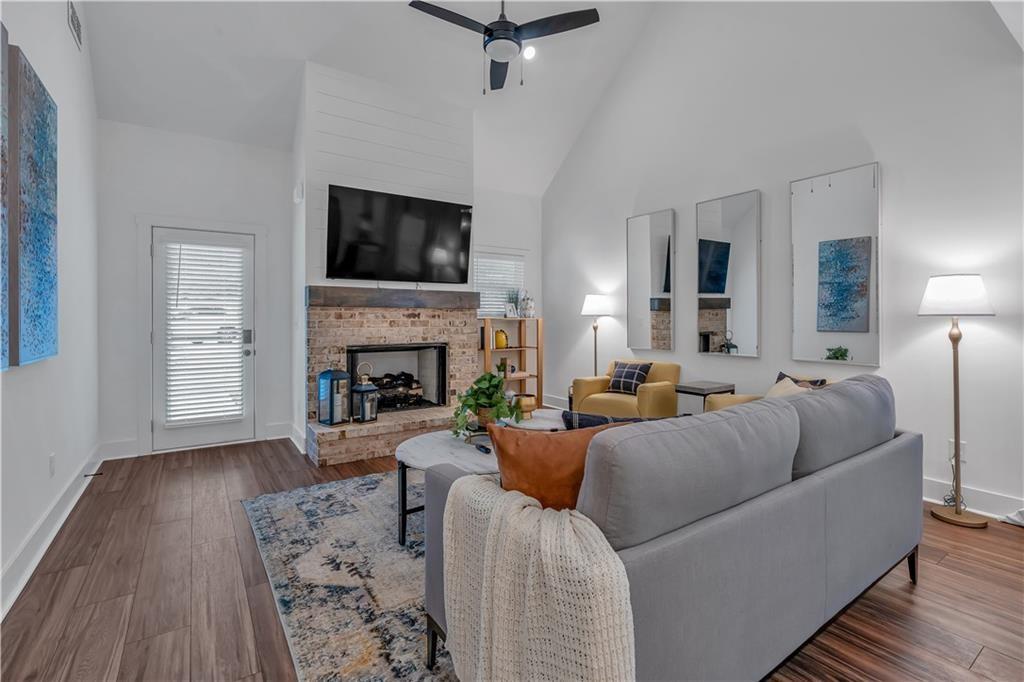 50 Puckett Road Emerson, GA 30137 - Photo 19 of 26 a living room with furniture a flat screen tv and a fireplace