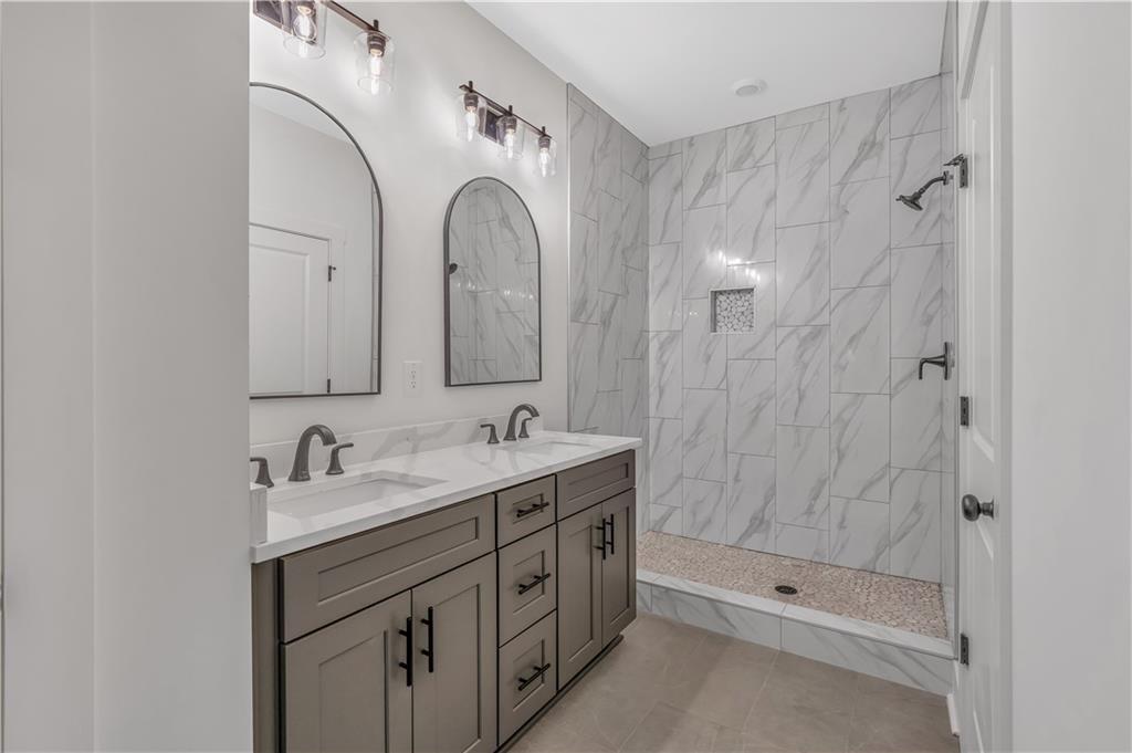 50 Puckett Road Emerson, GA 30137 - Photo 9 of 26 a bathroom with a double vanity sink mirror and shower