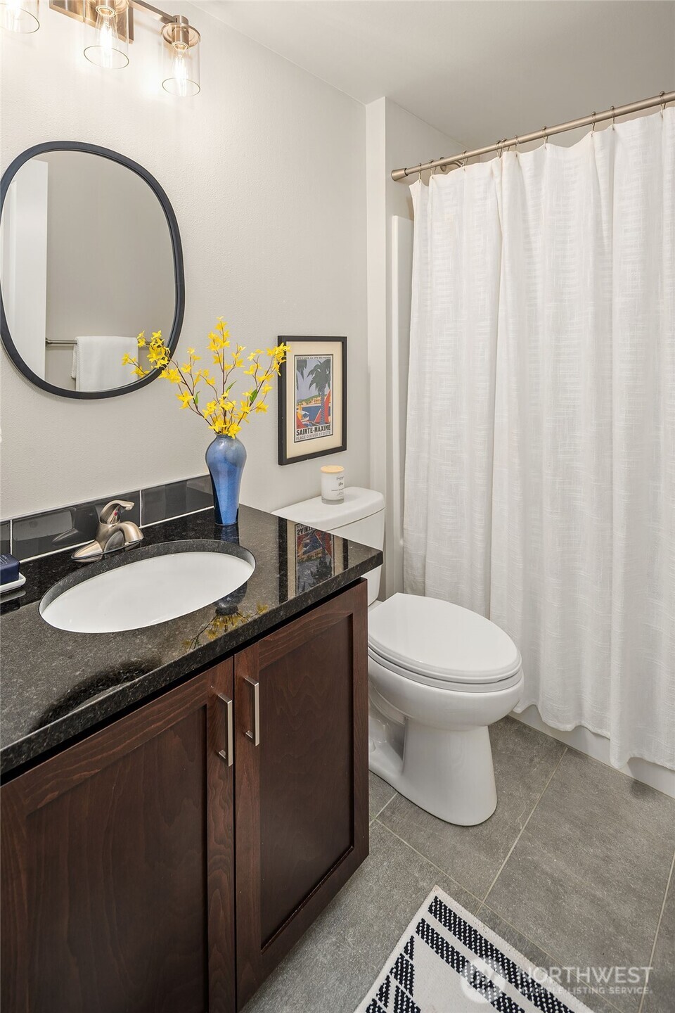 6908 31st Avenue Southwest Seattle, WA 98126 - Photo 28 of 33 a bathroom with a sink and a mirror