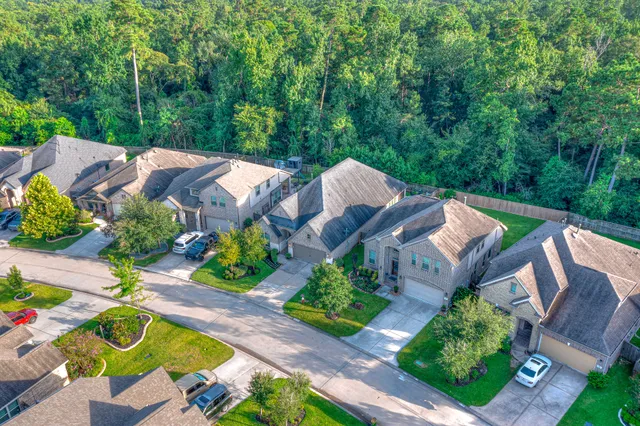 an aerial view of a house with garden space and street view