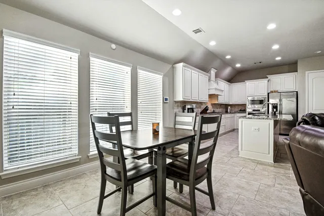 a kitchen with kitchen island wooden cabinets and stainless steel appliances