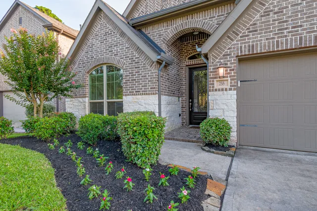 a front view of a house with garden