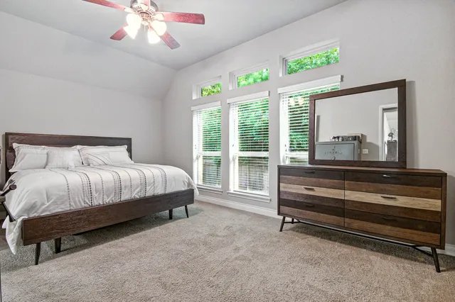 a bedroom with a bed and a large window