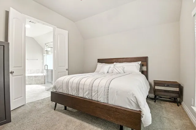 a bedroom with a bed and a mirror