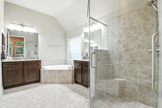 a bathroom with a granite countertop sink a toilet and bathtub