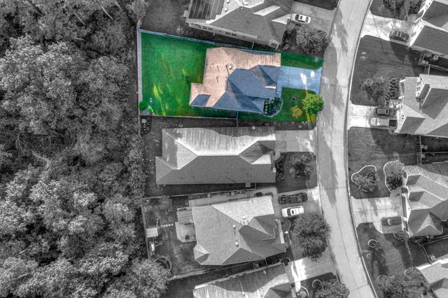 an aerial view of a house with yard swimming pool and outdoor seating