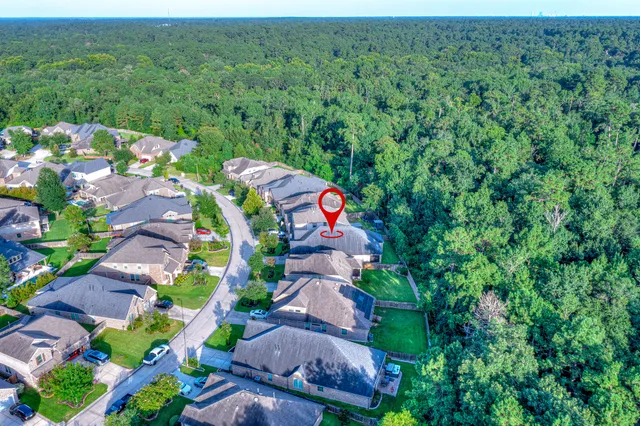 an aerial view of a house with a yard
