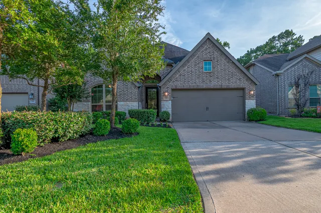 a front view of house with a garden