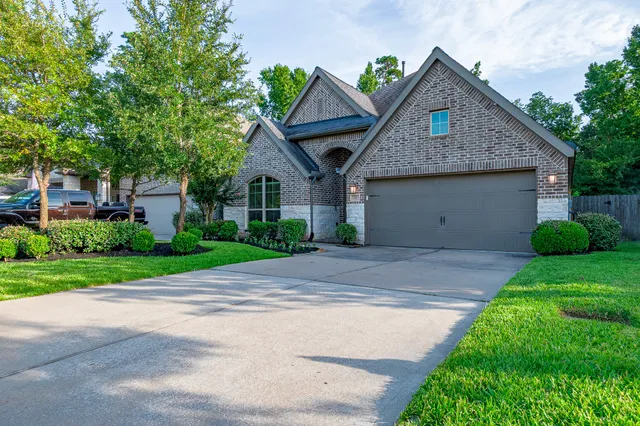 a front view of house with yard and green space