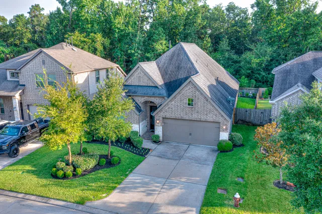 a aerial view of a house with a yard and potted plants