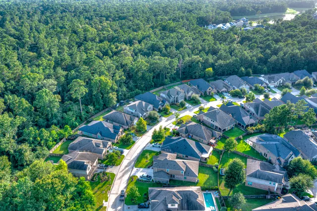 an aerial view of a house with a yard