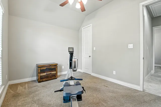 a living room with furniture a piano and a fan
