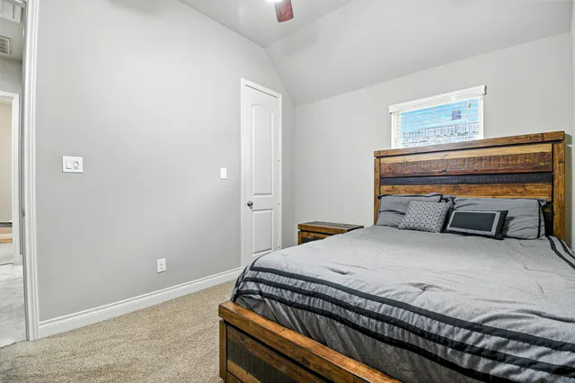 a bedroom with a bed and cabinet