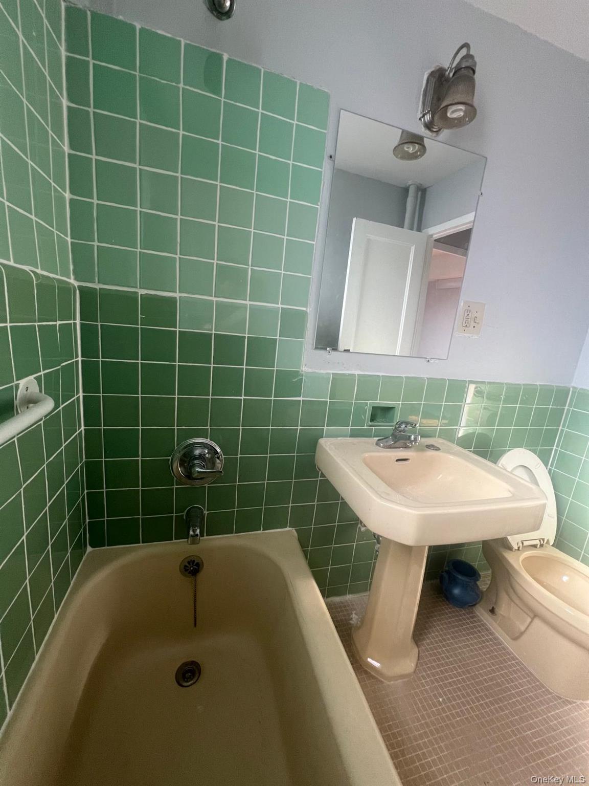 1314 Virginia Avenue, Unit 4F Bronx, NY 10462 - Photo 12 of 17 Full bathroom with tile patterned floors, tile walls, and bathtub / shower combination