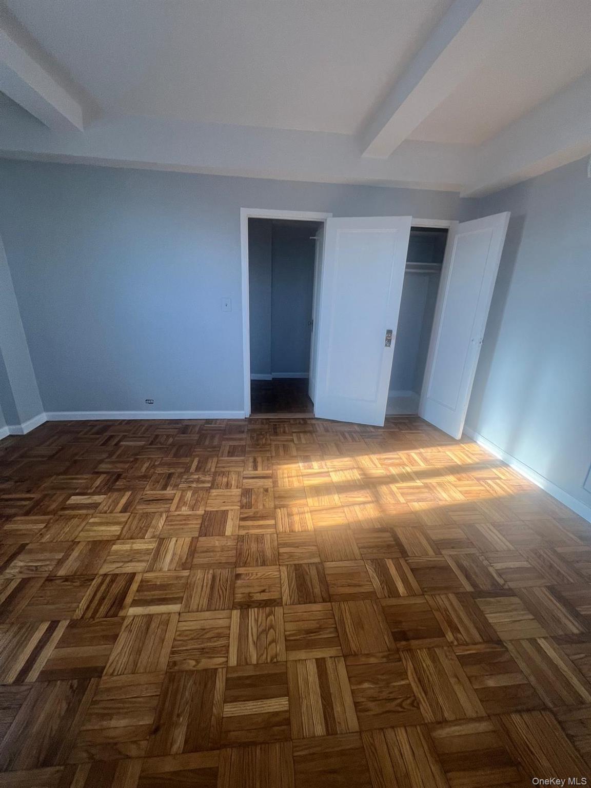 1314 Virginia Avenue, Unit 4F Bronx, NY 10462 - Photo 13 of 17 Unfurnished bedroom featuring beam ceiling and a closet