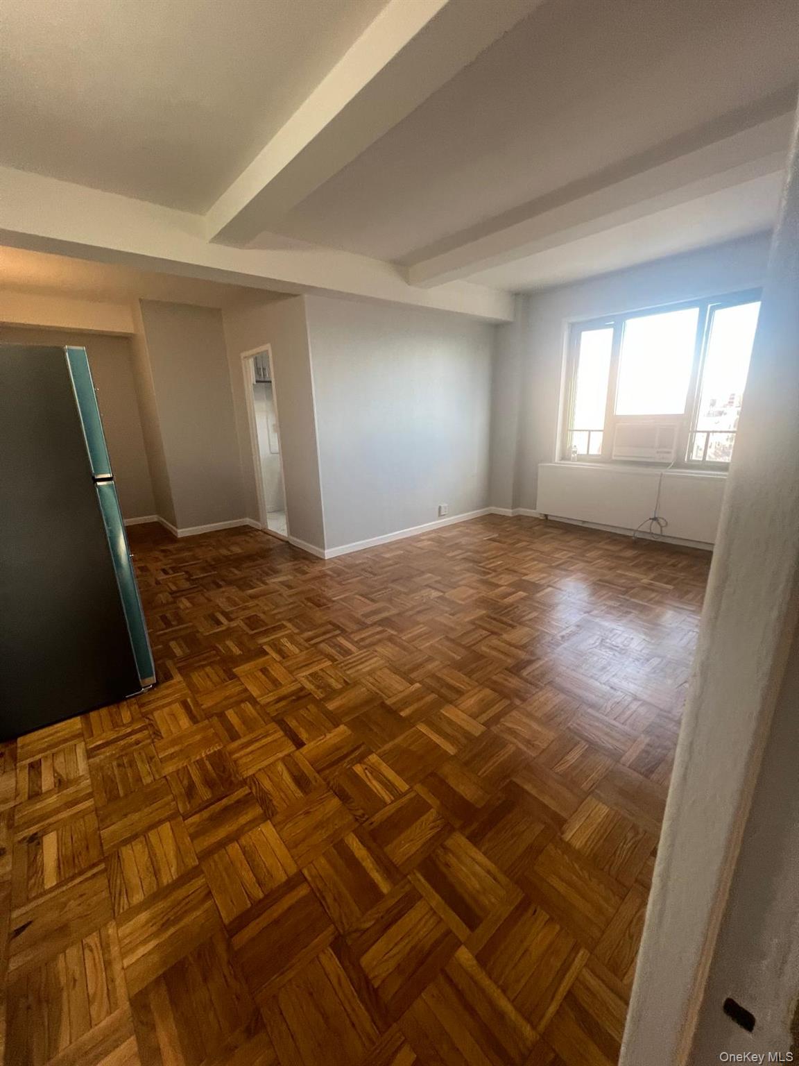 1314 Virginia Avenue, Unit 4F Bronx, NY 10462 - Photo 5 of 17 Unfurnished room featuring beam ceiling and baseboards