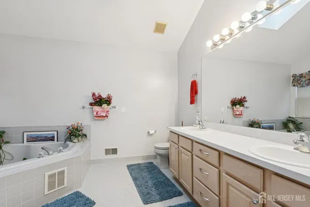 a bathroom with a sink a vanity and a mirror