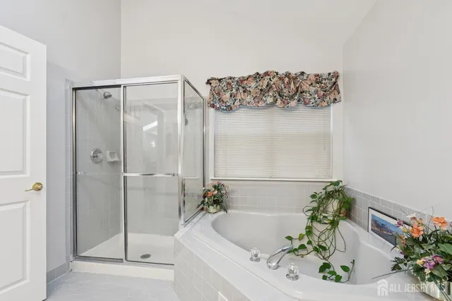 a bath tub sitting next to a white sink