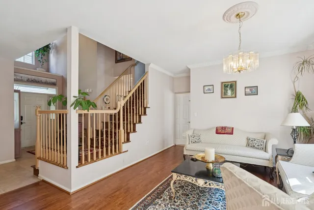 a view of a livingroom with wooden floor and furniture