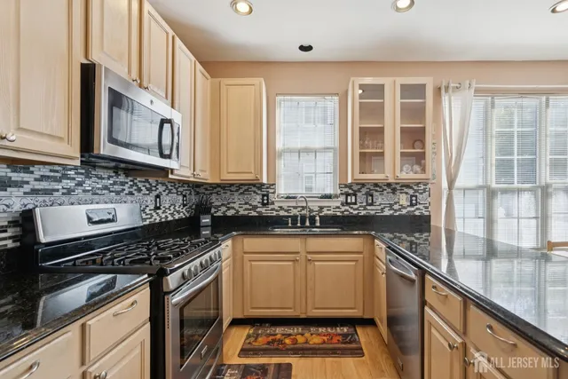a kitchen that has a sink and a stove