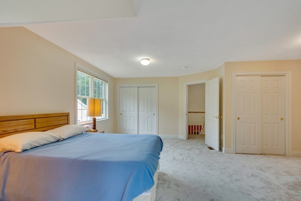 96 Summer Road, Unit 96 Boxborough, MA 01719 - Photo 22 of 26 a bedroom with a bed and a couch