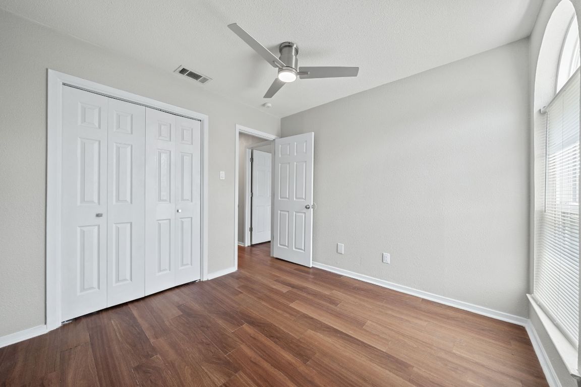 1810 Mearns Meadow Boulevard, Unit B Austin, TX 78758 - Photo 15 of 21 a view of an empty room with wooden floor