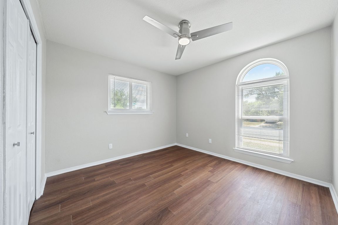 1810 Mearns Meadow Boulevard, Unit B Austin, TX 78758 - Photo 16 of 21 wooden floor in an empty room with a window