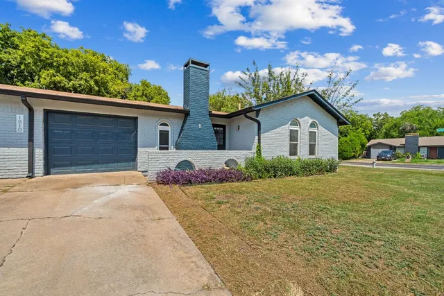 a bathroom with a granite countertop sink a toilet and a mirror
