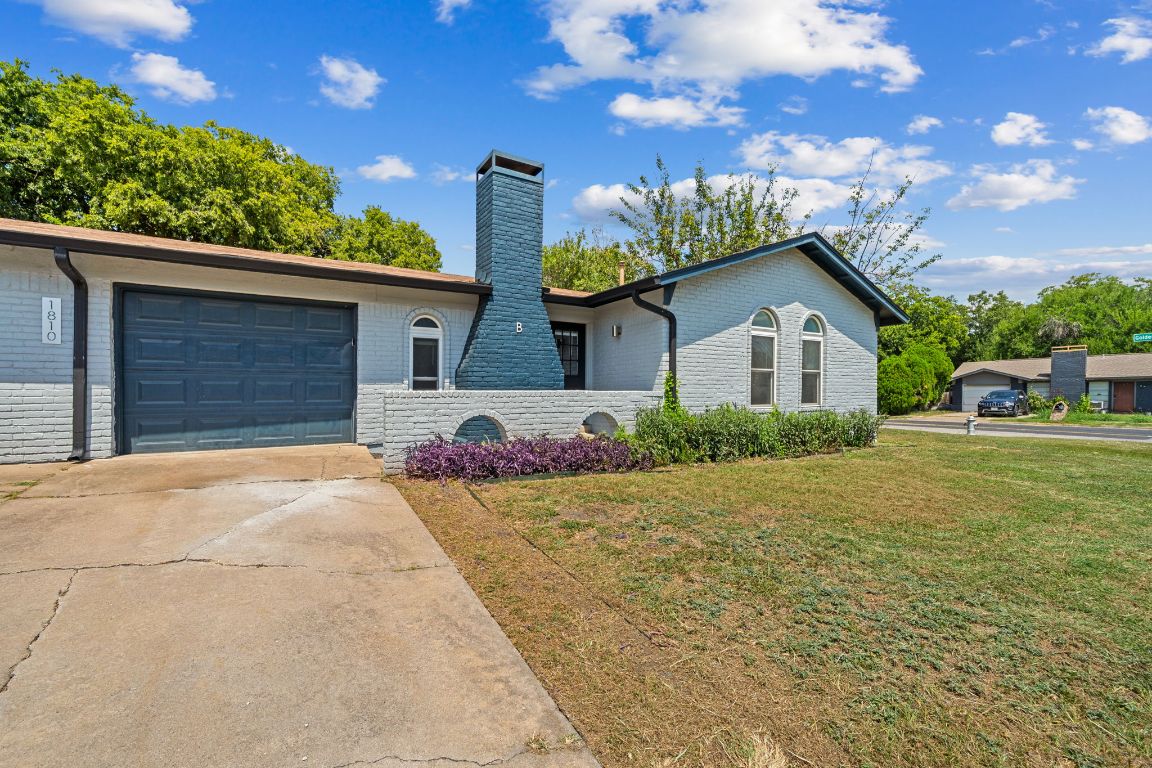 1810 Mearns Meadow Boulevard, Unit B Austin, TX 78758 - Photo 20 of 21 a front view of a house with garden