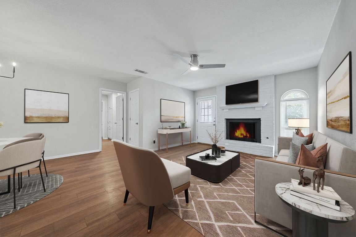 1810 Mearns Meadow Boulevard, Unit B Austin, TX 78758 - Photo 3 of 21 a living room with furniture a fireplace and a flat screen tv