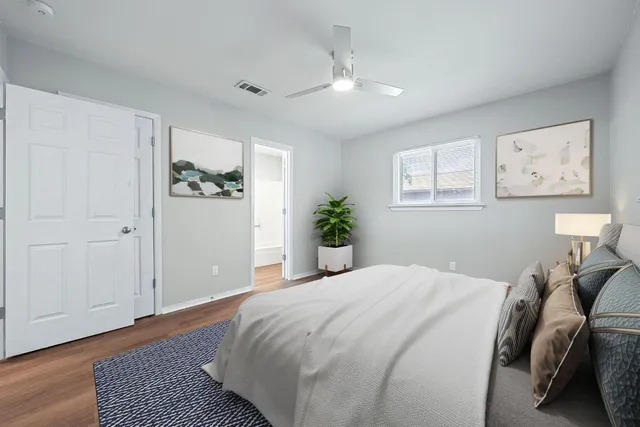 a bedroom with a bed and a painting on the wall