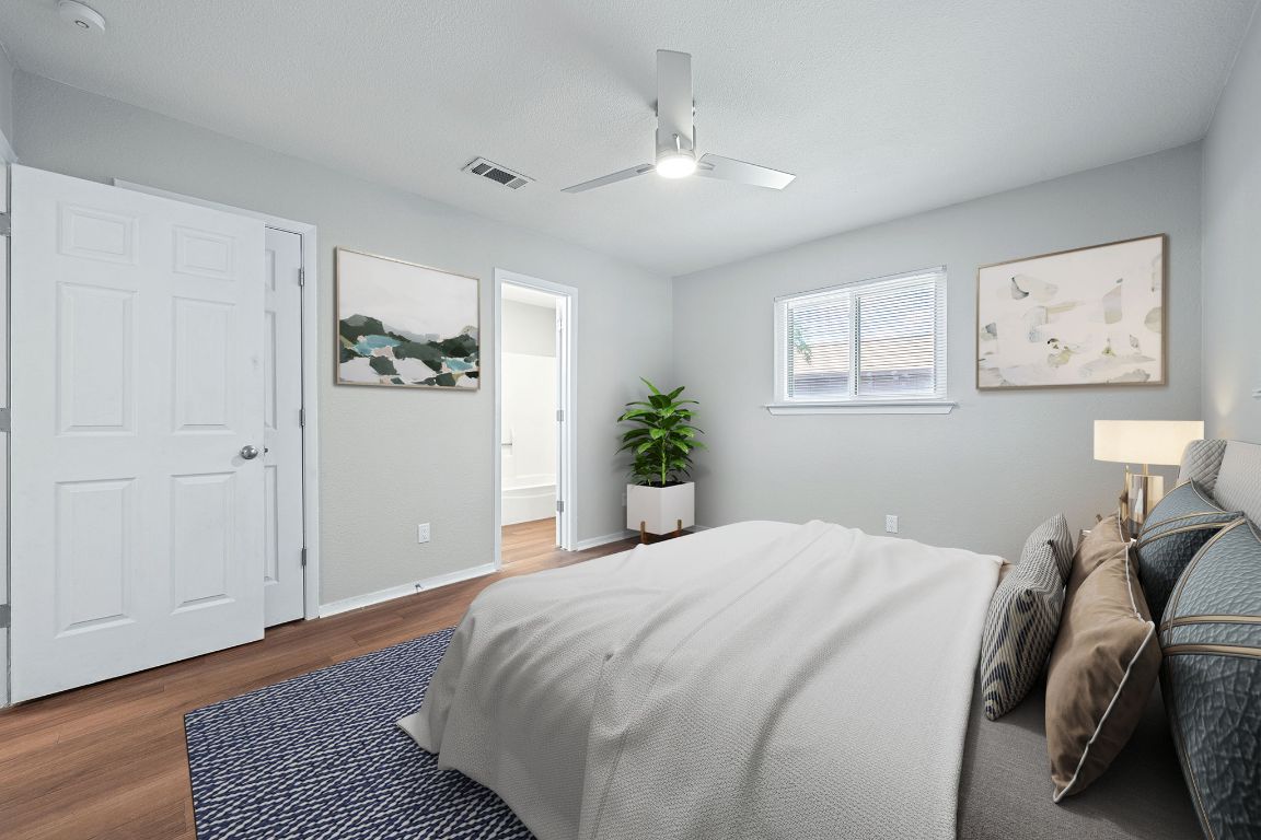 1810 Mearns Meadow Boulevard, Unit B Austin, TX 78758 - Photo 5 of 21 a bedroom with a bed and a painting on the wall