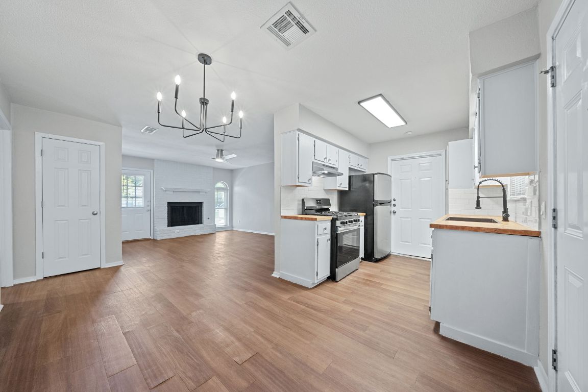 1810 Mearns Meadow Boulevard, Unit B Austin, TX 78758 - Photo 21 of 21 a view of kitchen with sink microwave and refrigerator