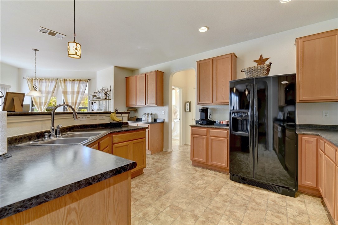 145 Rudy Lane Kyle, TX 78640 - Photo 13 of 29 a kitchen with a sink a counter top stainless steel appliances and cabinets
